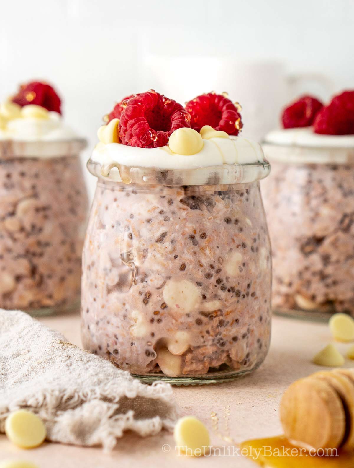 White chocolate raspberry overnight oats in individual jars.