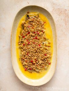 Pork mixture added to eggplant.