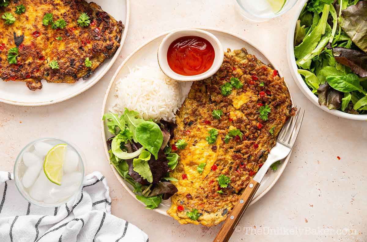 Filipino eggplant omelette with a side of vegetables.