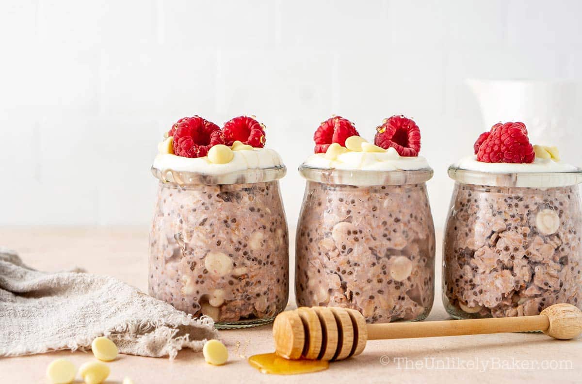 Raspberry white chocolate overnights oats topped with fresh raspberries.