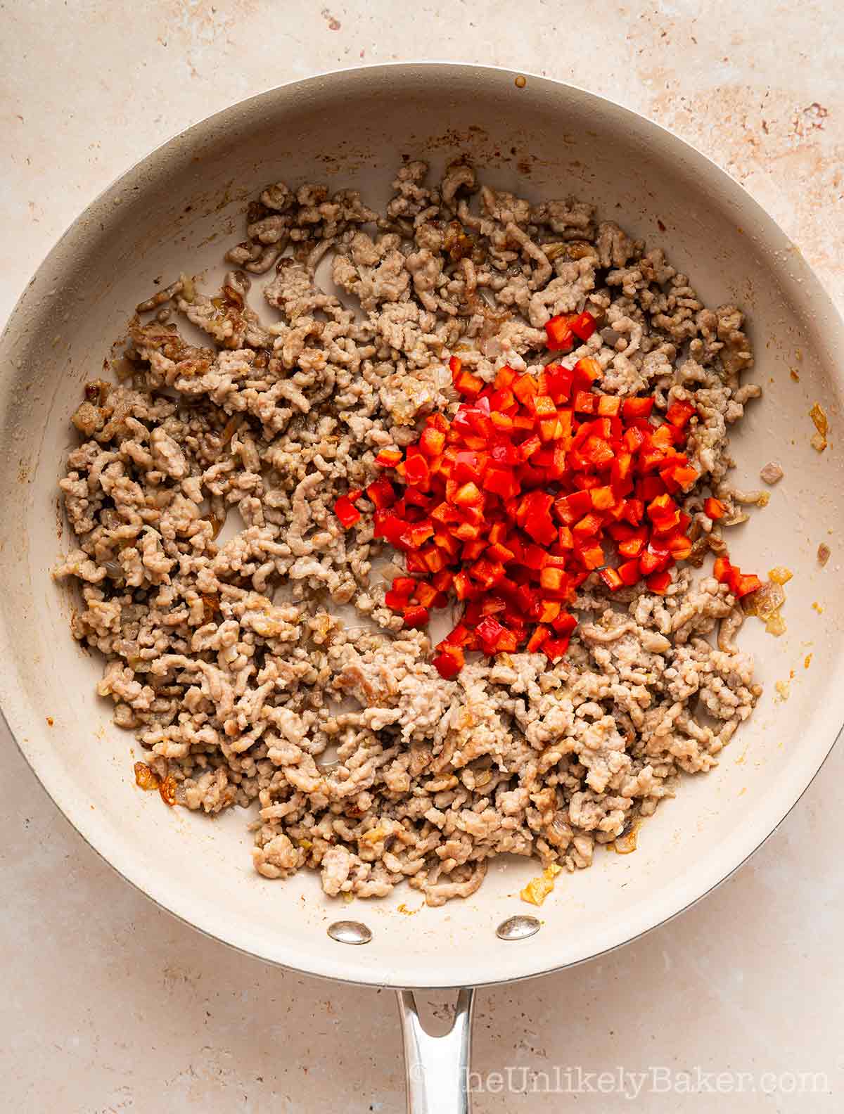Bell peppers added to ground pork.
