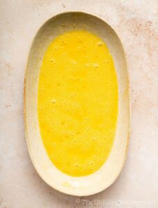 Beaten eggs on a plate.