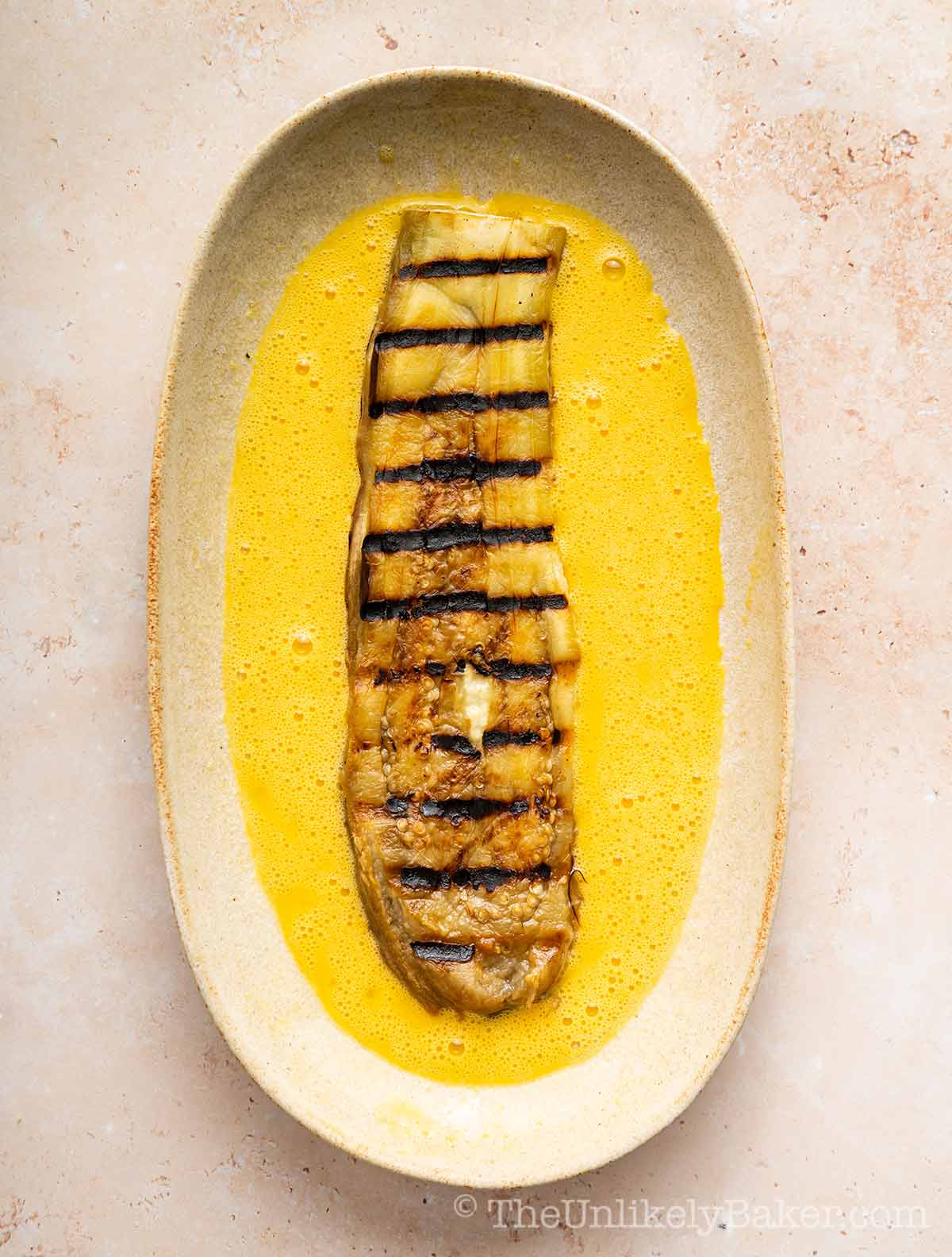 Grilled eggplant placed on eggs.