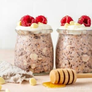 Raspberry and white chocolate oats topped with fresh raspberries.