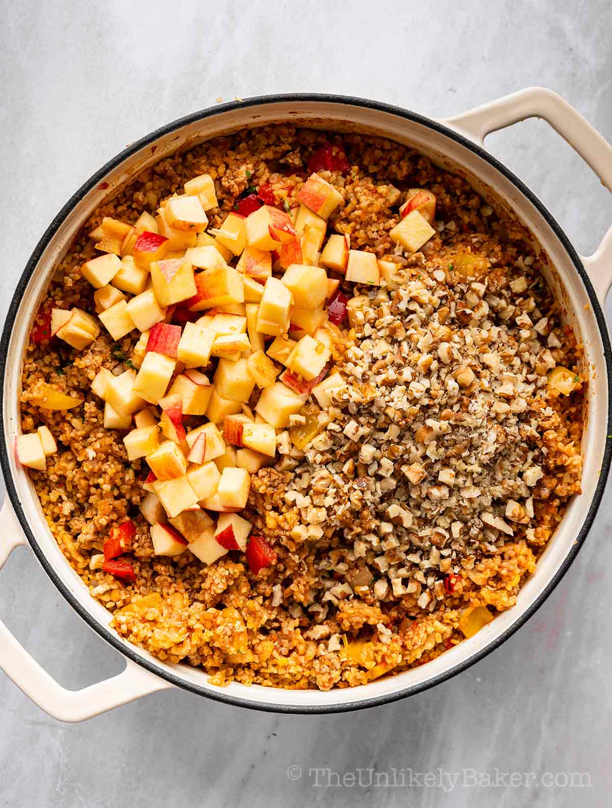 Apples and walnuts added to cooked bulgur.