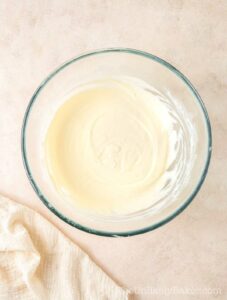 Melted cream cheese in a bowl.