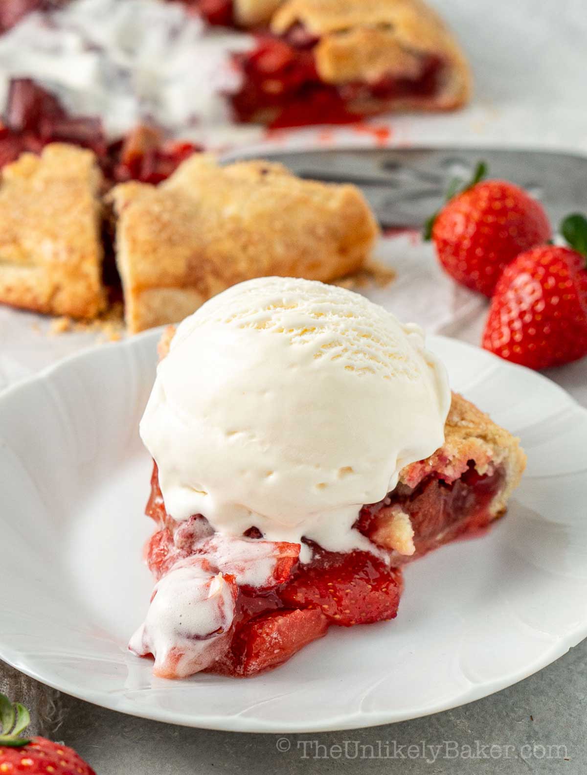 A slice of old fashioned strawberry and rhubarb free-form tart.