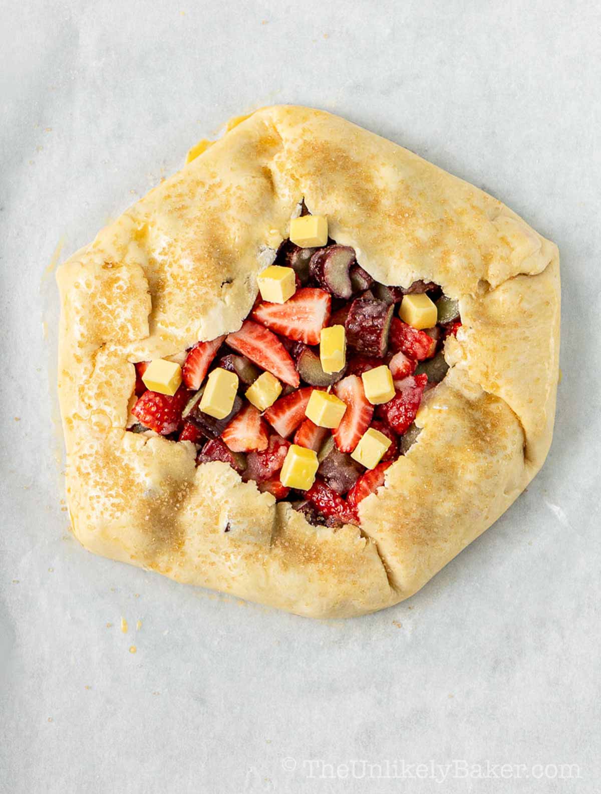 Cold butter and demerara sugar added to galette.