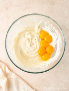 Egg yolks added to cream cheese.