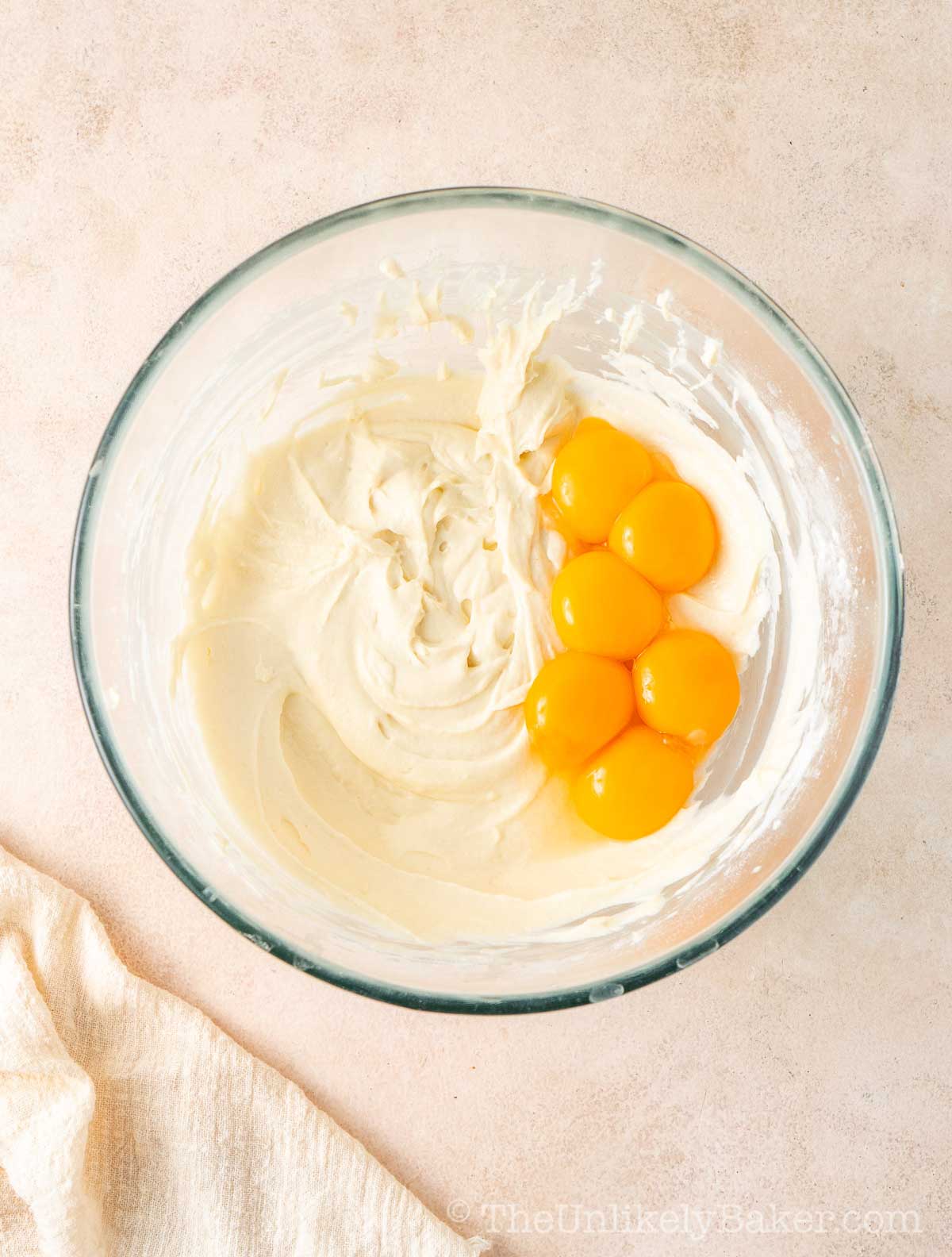 Egg yolks added to cream cheese.