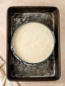 Cheesecake batter in a cake pan.