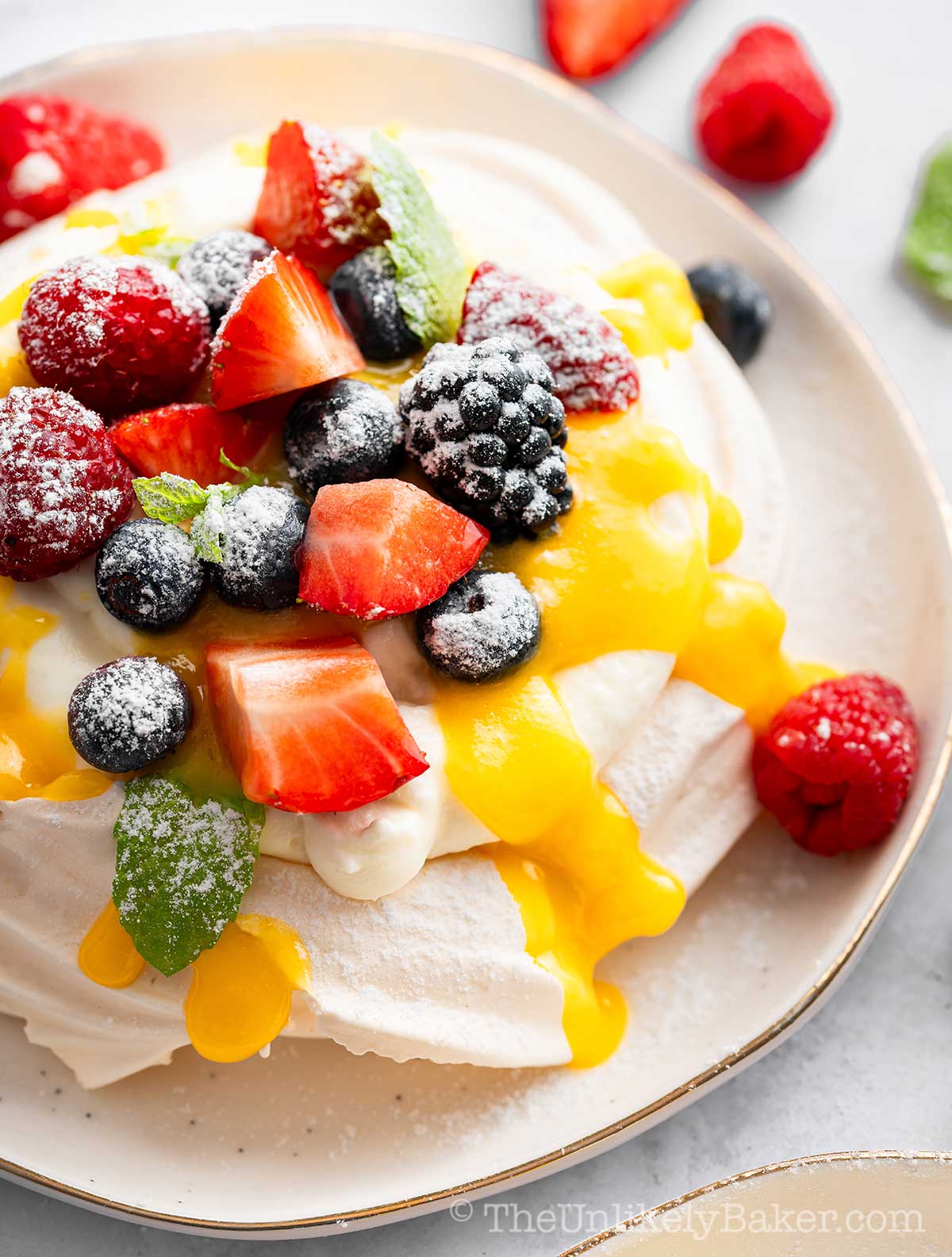 Pavlova with lemon curd, cream and berries.