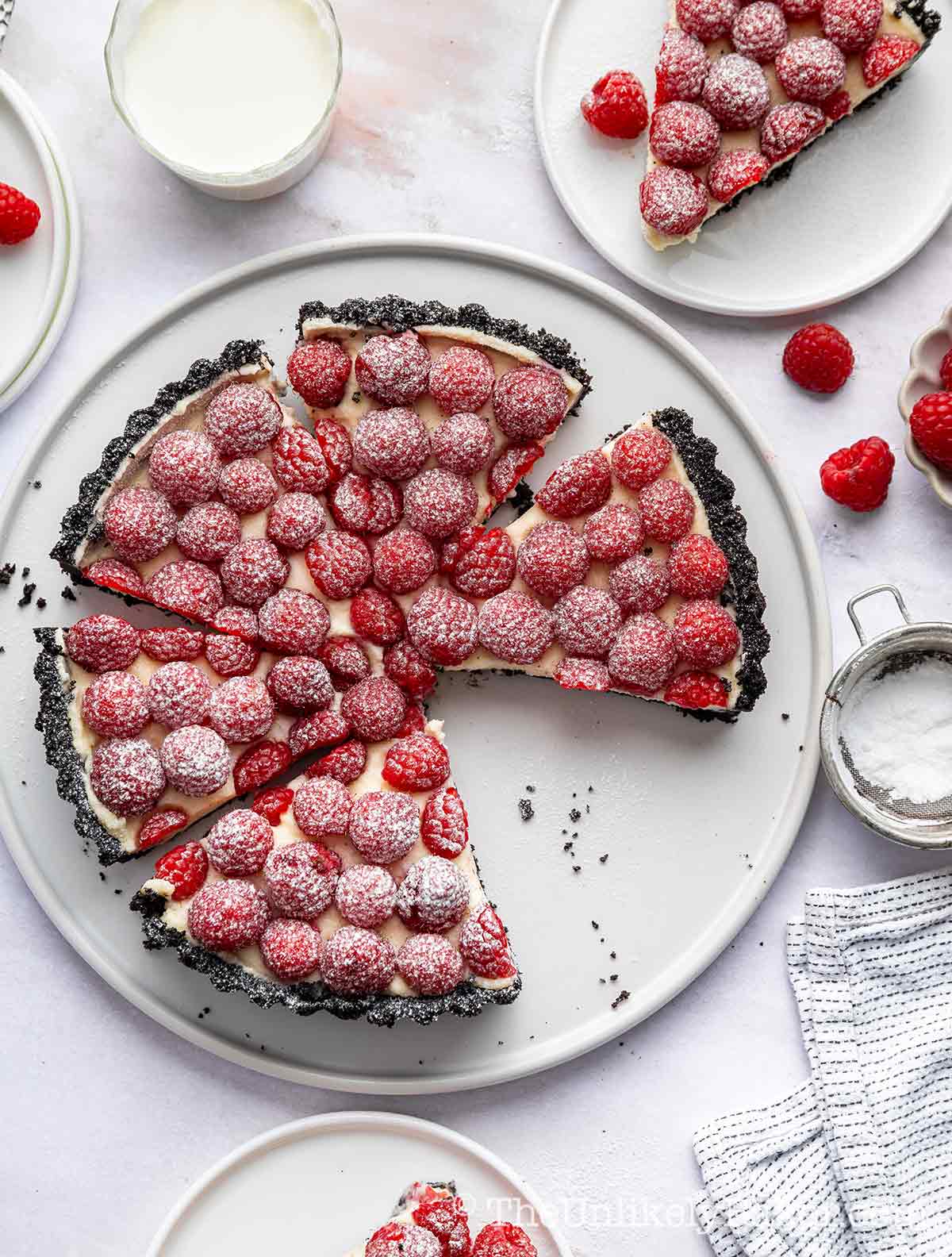 Raspberry and white chocolate tart with Oreo cookie crust.