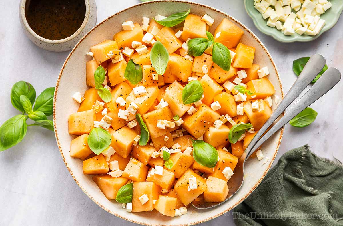 Cantaloupe feta cheese salad topped with fresh basil.