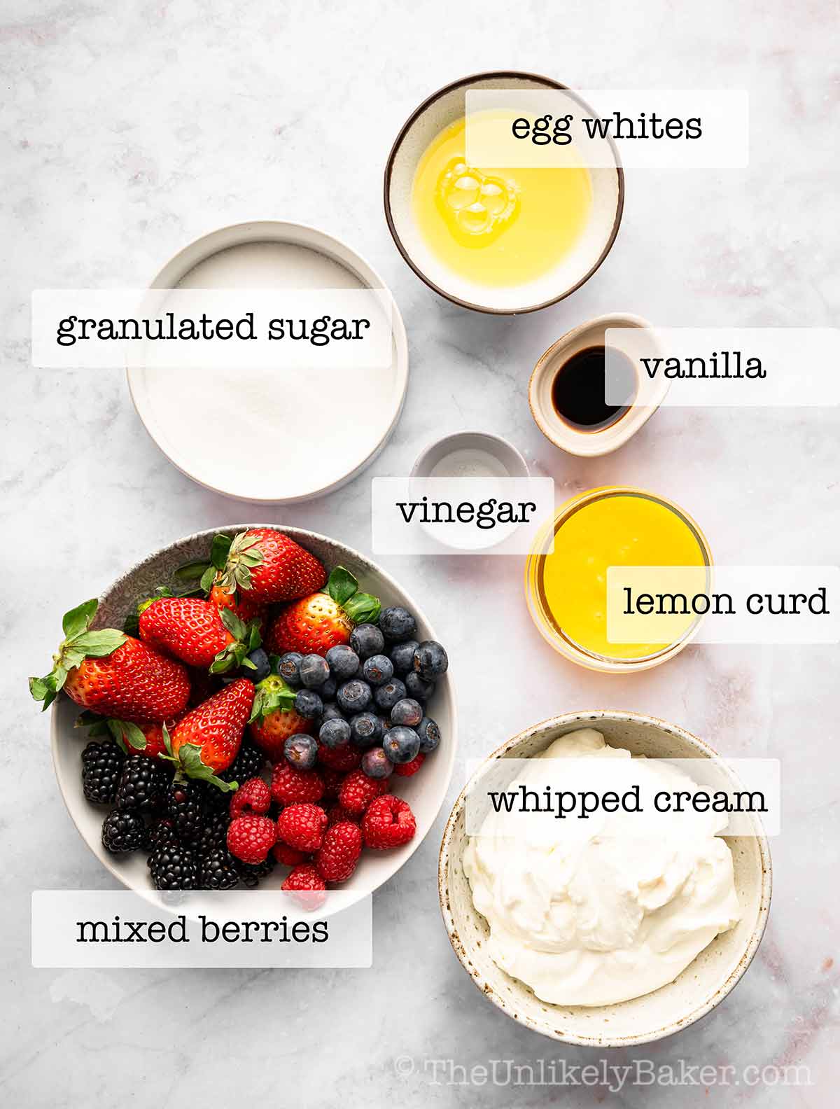 Ingredients for lemon curd pavlova with text overlay.