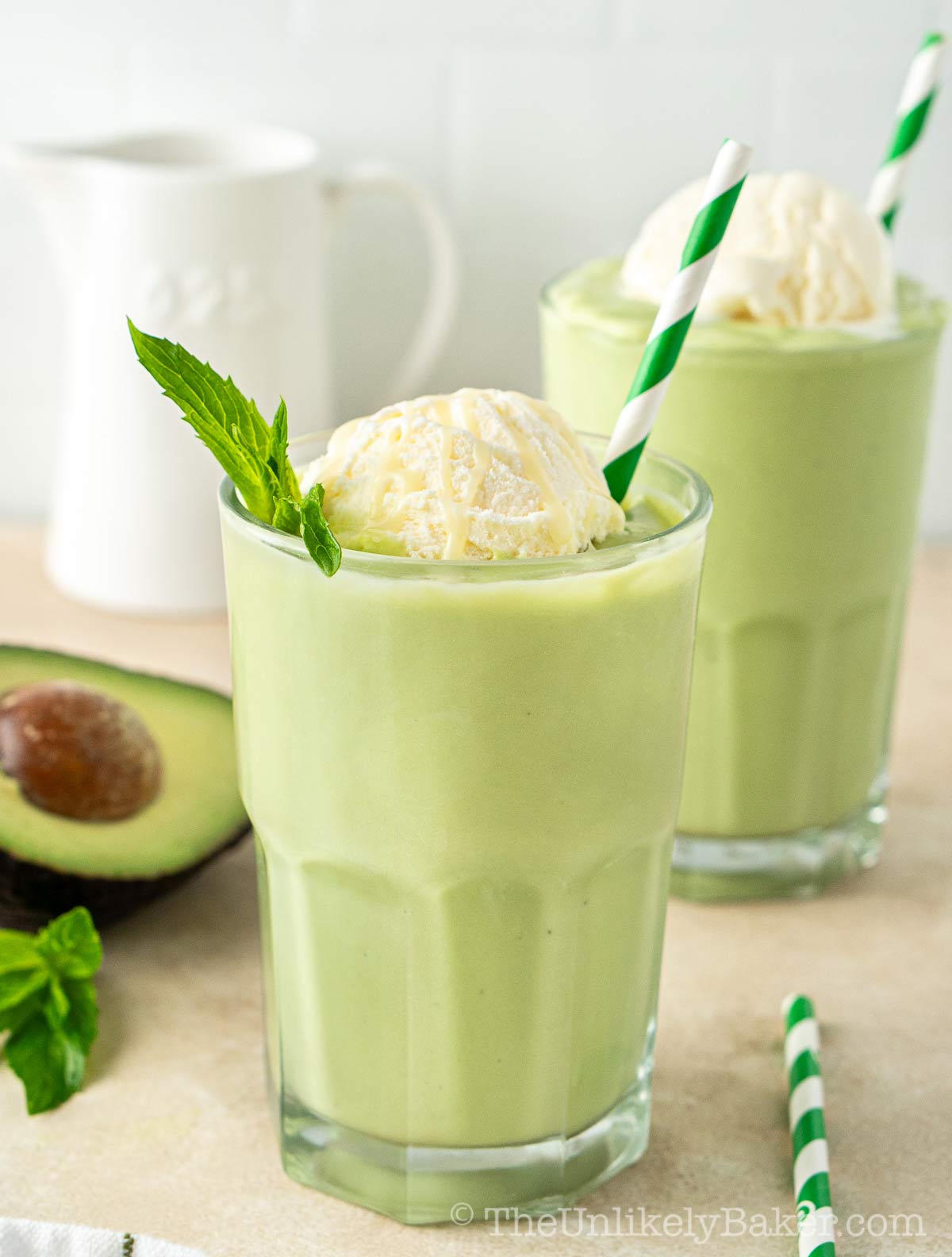 Avocado milkshake in serving glasses.