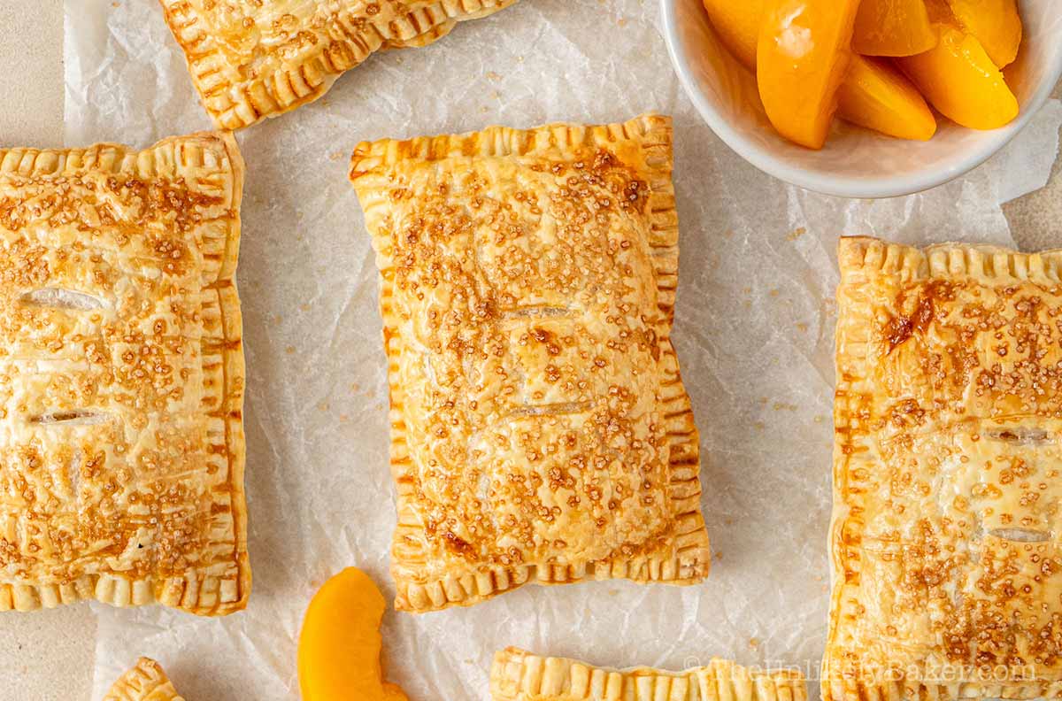 Crispy flaky baked peach mango hand pies.