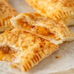 Crispy flaky peach mango pie with a gooey fruit filling.