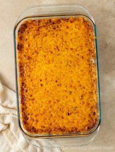 Freshly baked ube cassava cake in a baking dish.