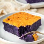 Slice of ube cassava cake with cheese.