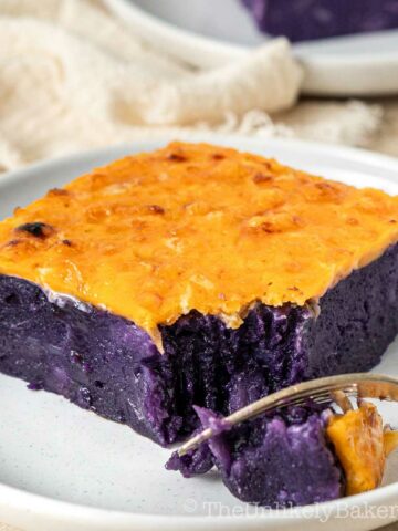 Slice of ube cassava cake with cheese.