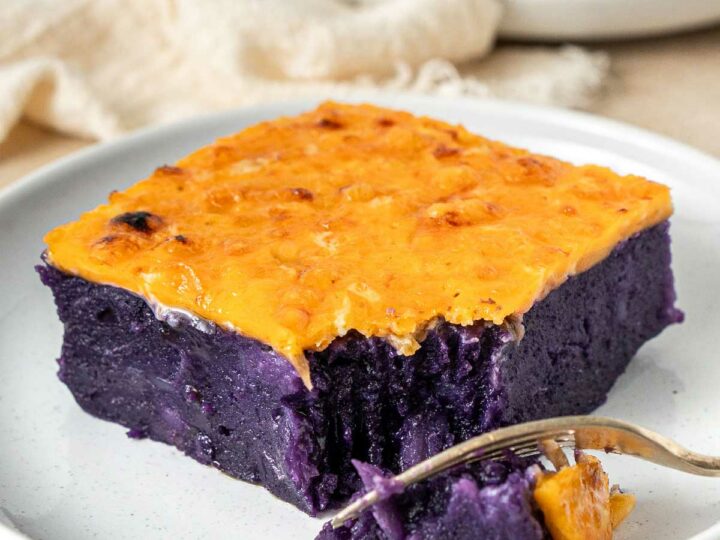 Slice of ube cassava cake with cheese.