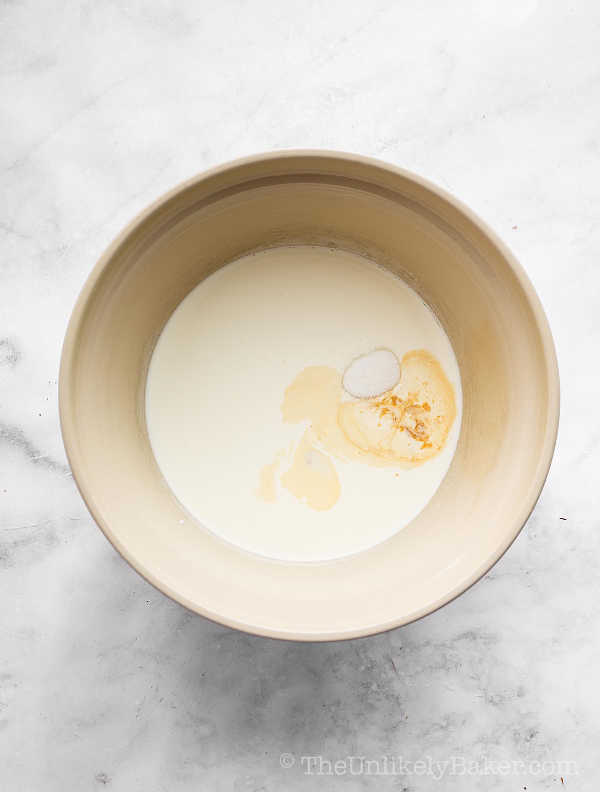 Heavy cream and vanilla in a bowl.