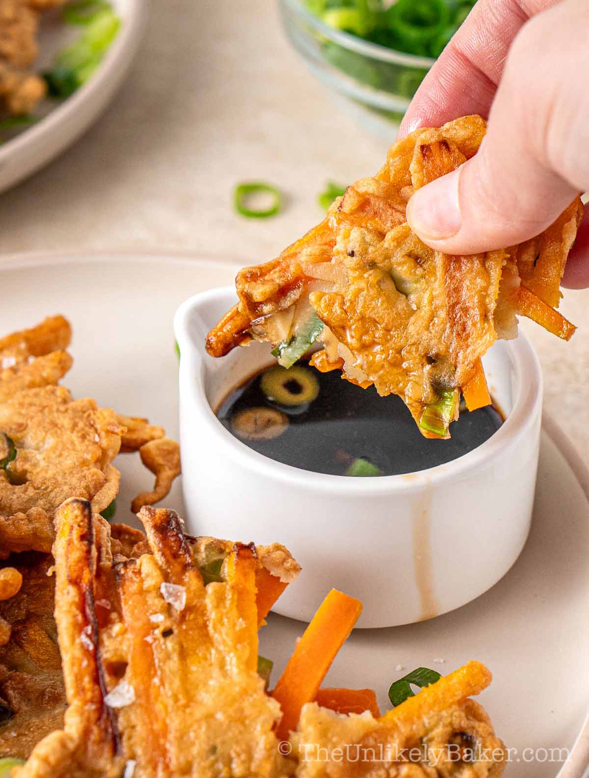 Kalabasa fritter dipped into vinegar dipping sauce.