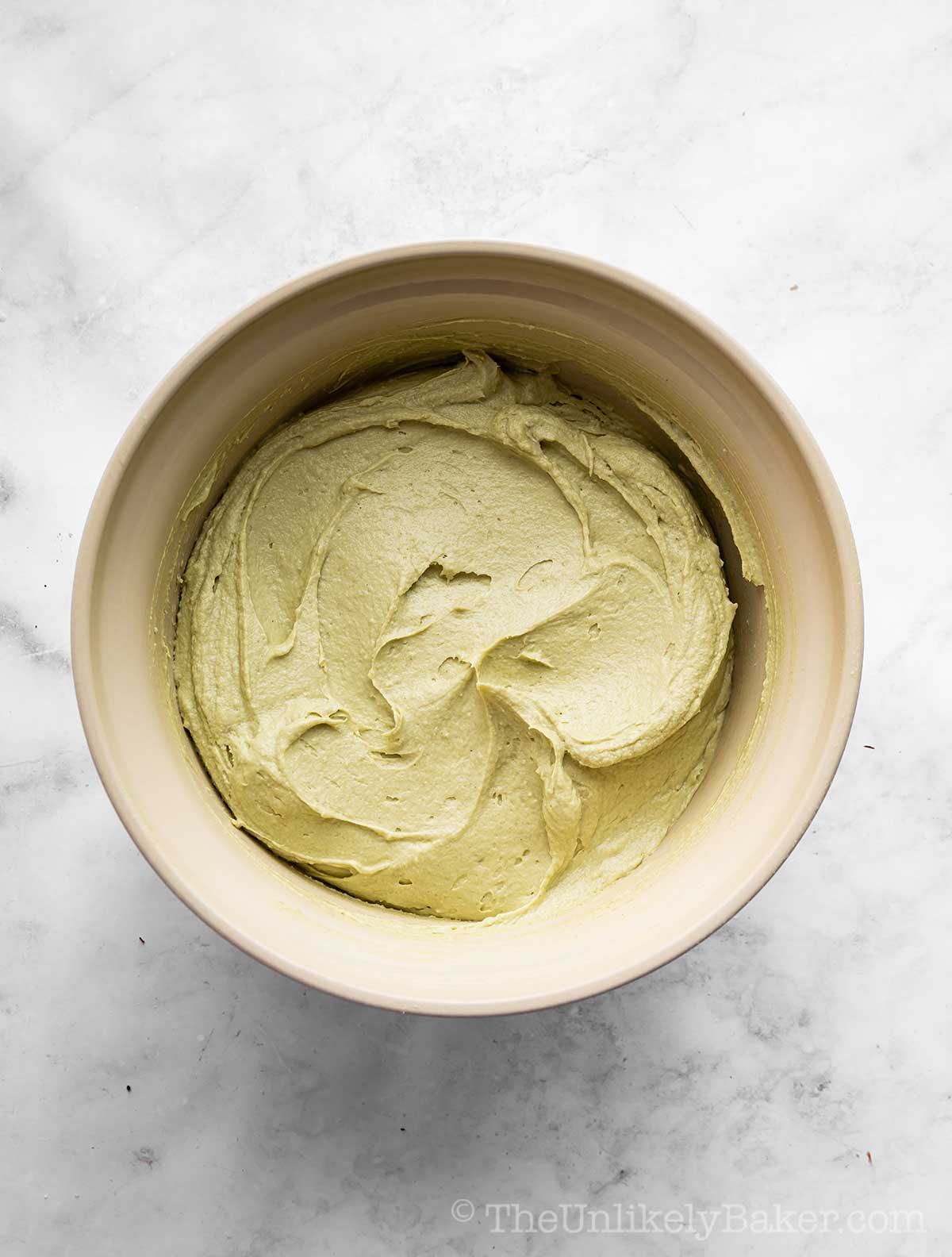 Pistachio cream mixture in a mixing bowl.