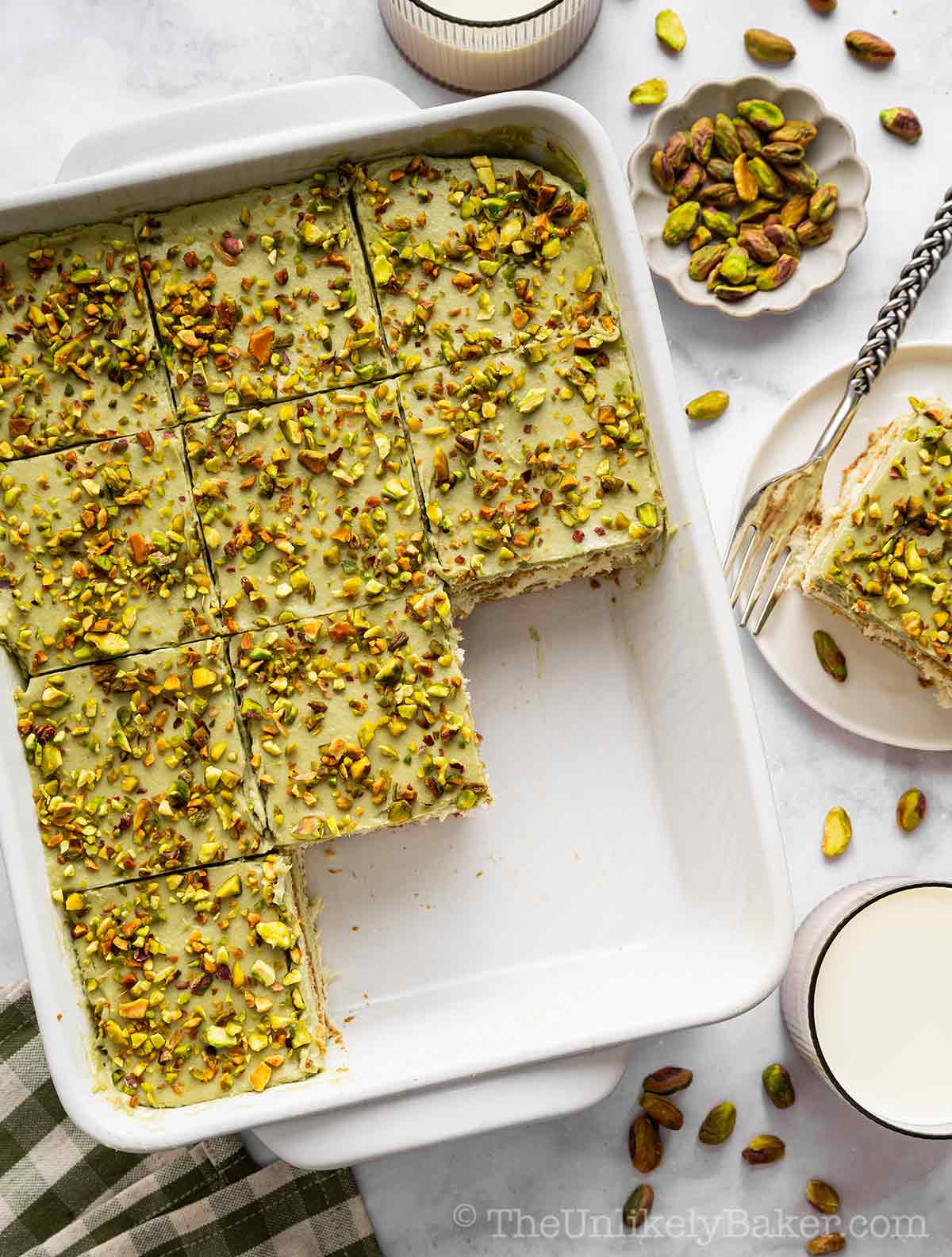 Tiramisu with pistachio cream on a baking dish.