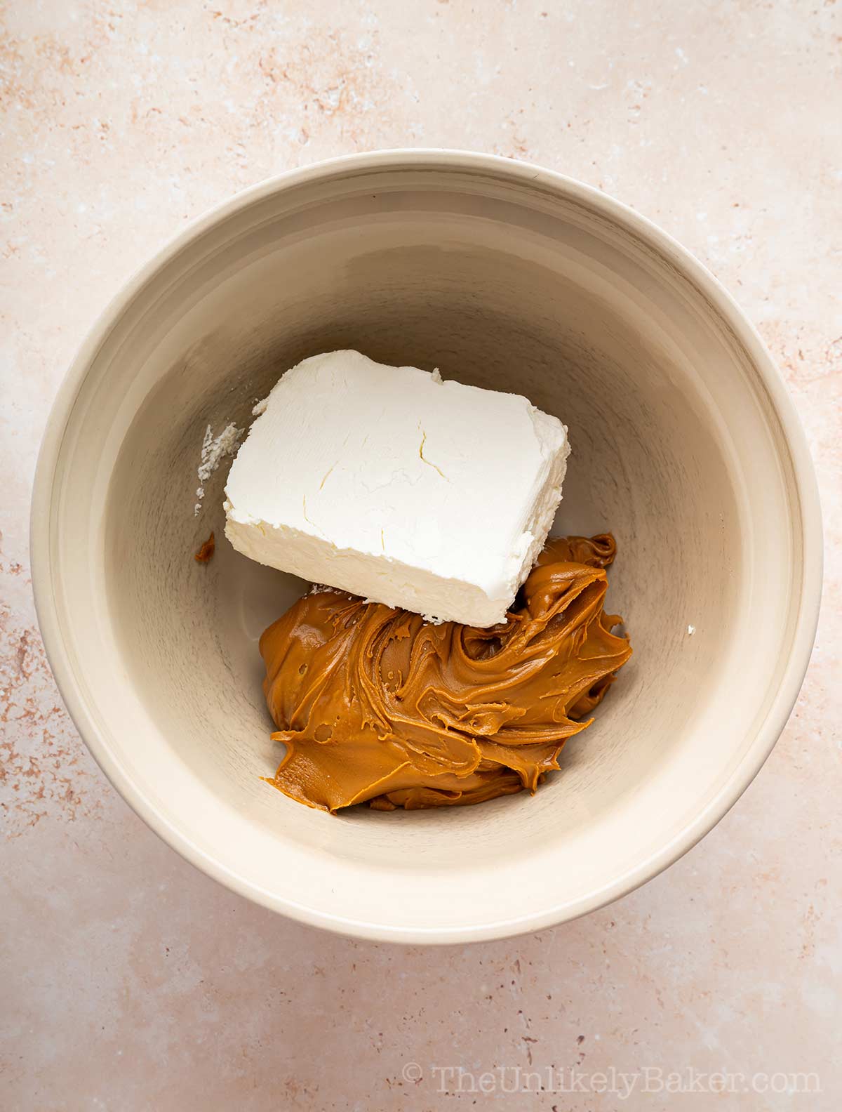 Cream cheese and cookie butter in a bowl.