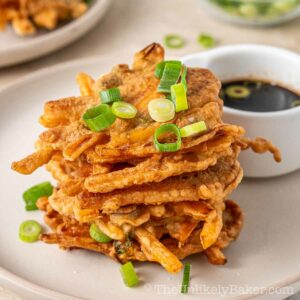 A stack of okoy kalabasa with dipping sauce.