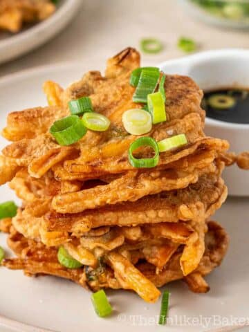 A stack of okoy kalabasa with dipping sauce.