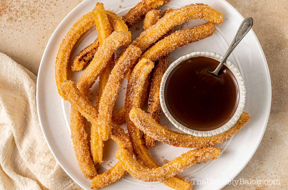 Churros on chocolate on a plate.